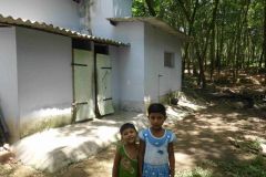 Bency-and-sister-outside-their-toilet